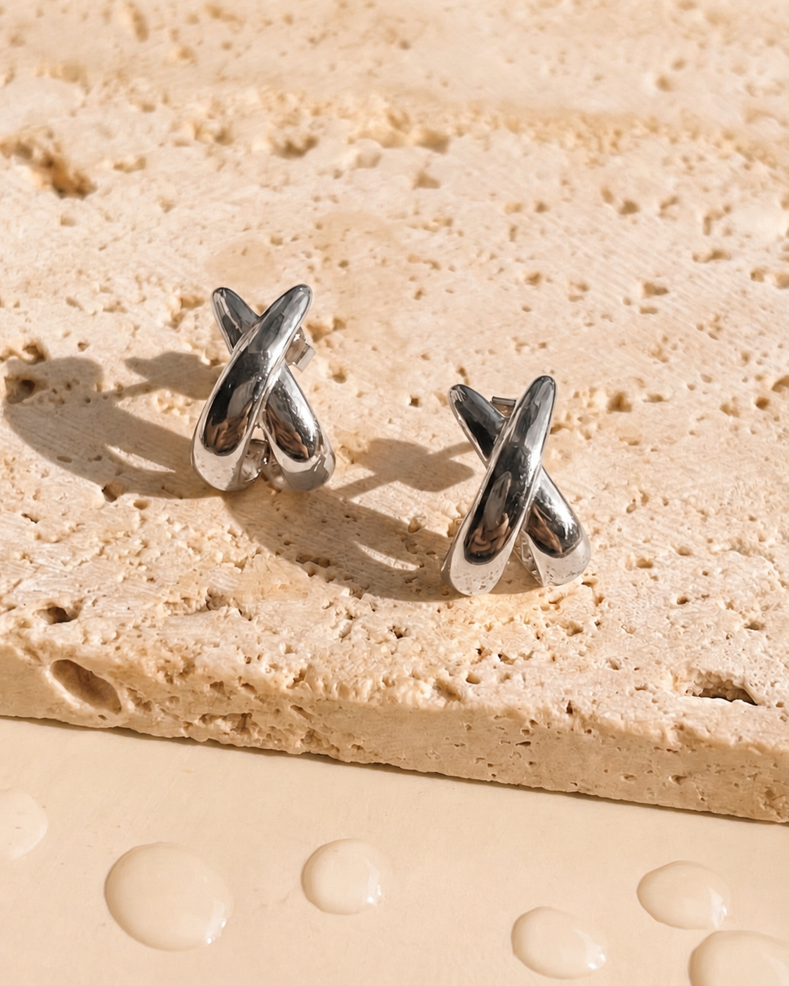 Idra (Silver) Intercrossed Flat C Shaped Huggies Silver Stud Earrings