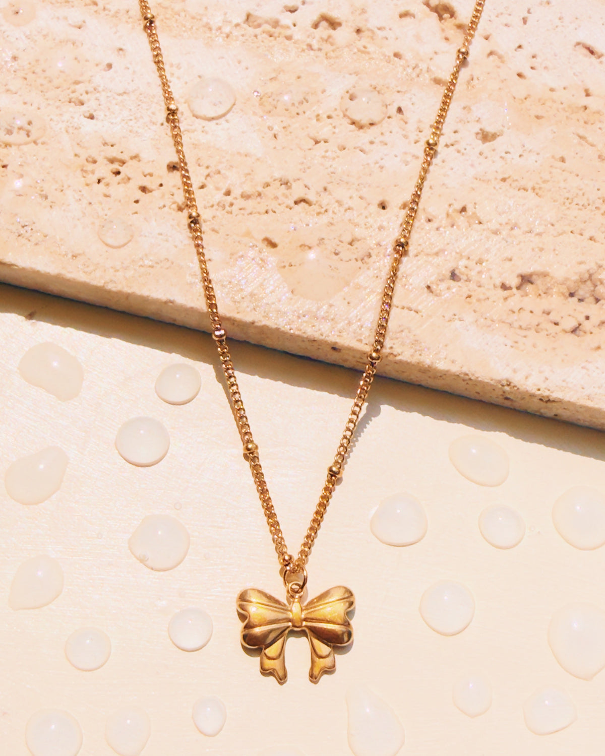 Oksana Solid Bow Ribbon Pendant Ball Beaded Curb Link Chain Design Gold Necklace